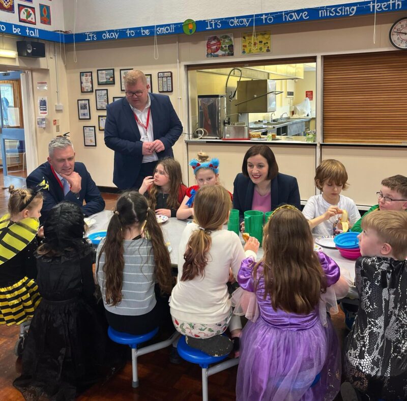 Bridget (centre) at a breakfast club with children and David Smith MP (far left)