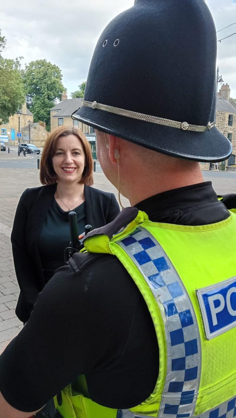Bridget (left) with a local police officer (right, foreground)